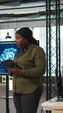 vertical video female programmer coding ai algorithms on tablet to debug software issues