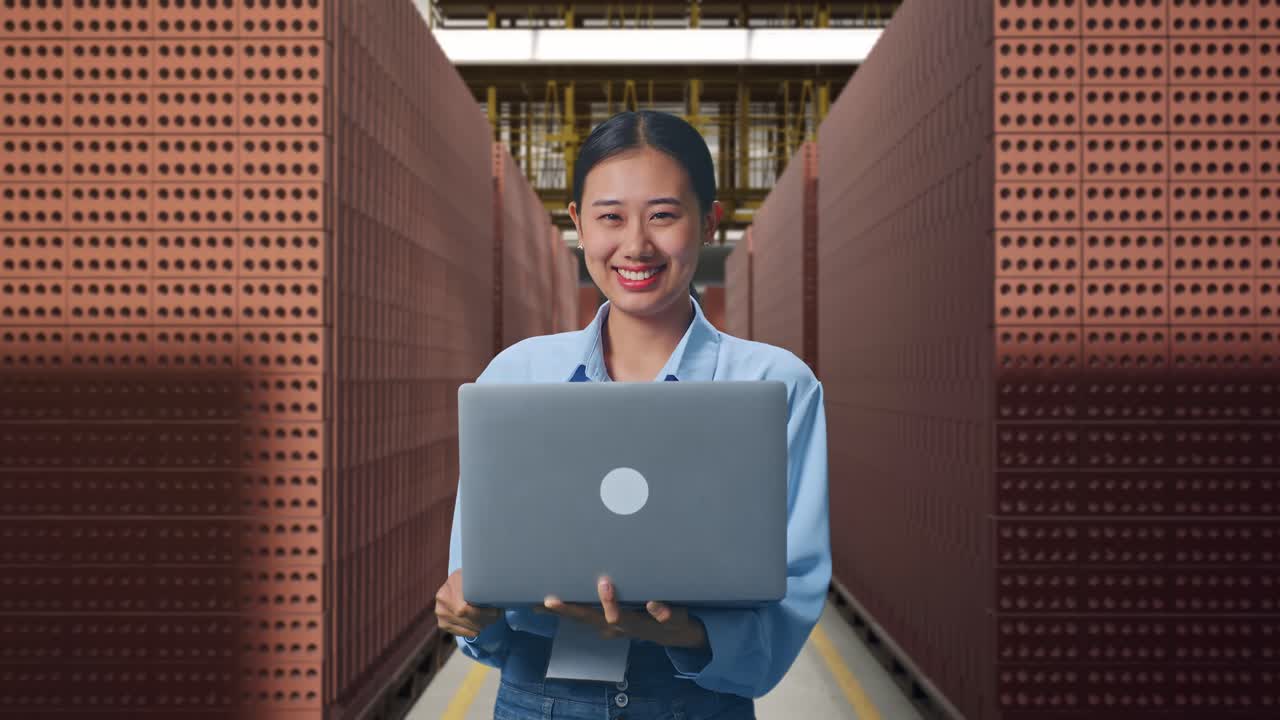 Woman Working in a Brick Factory with Laptop
