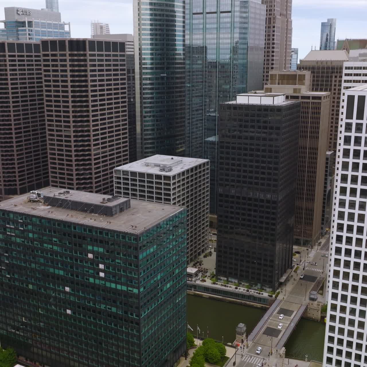 Magnificent buildings of modern Chicago. Quick gaze at the river flowing between the houses. Aerial perspective