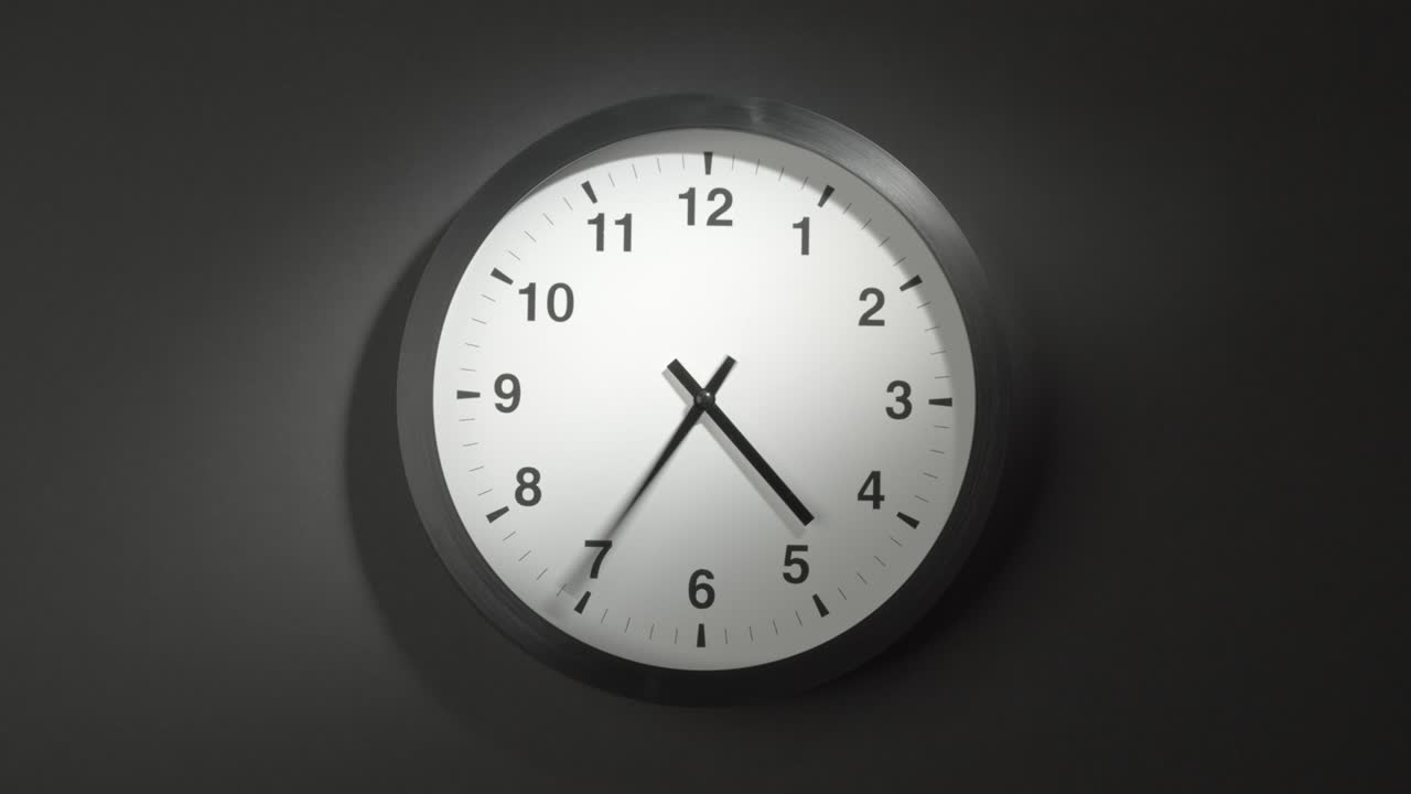 Clock Face in Time Lapse on Dark Grey Wall