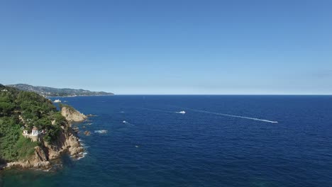 Flyover-Resort-Pool-with-Amazing-Ocean-View-at-Popular-Wedding-Location-Convent-de-Blanes,-Spain,-Aerial