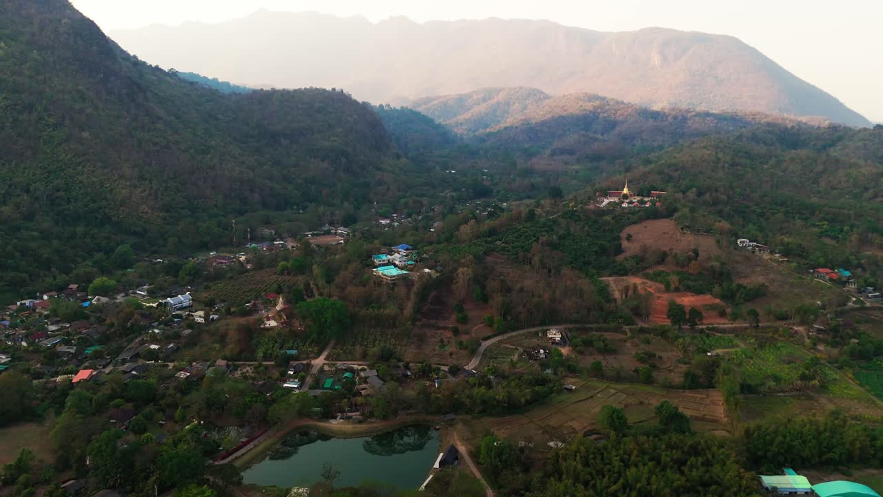 Drone above Chiang Dao in Chiang Mai Province, Thailand mountain view at sunset