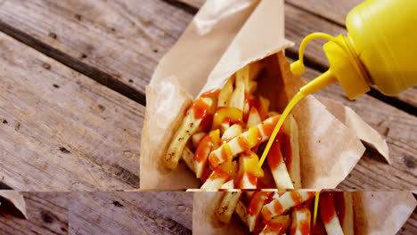 Mustard-sauce-being-squeezed-over-french-fried-chips-on-tray