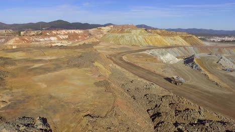 heavy machinery working in te riotinto open pit copper mine aerial shot