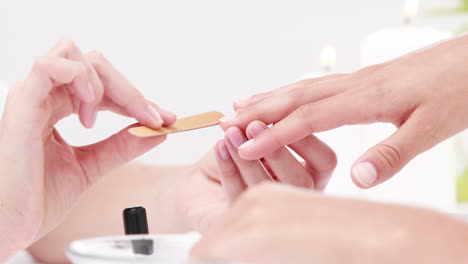 woman getting a manicure at nail salon