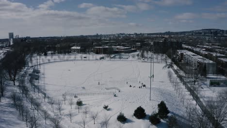 4K-winter-sleighride-sliding-hills---drone---fast---towards-park
