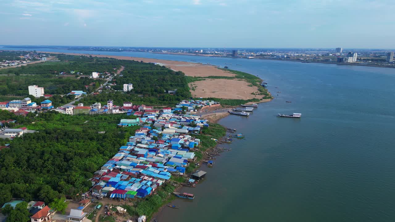 fishing village with colorful shacks along the Mekong river in Cambodia, a developing country in Southeast Asia. Unique aerial view flight speed ramp hyper motion time lapse