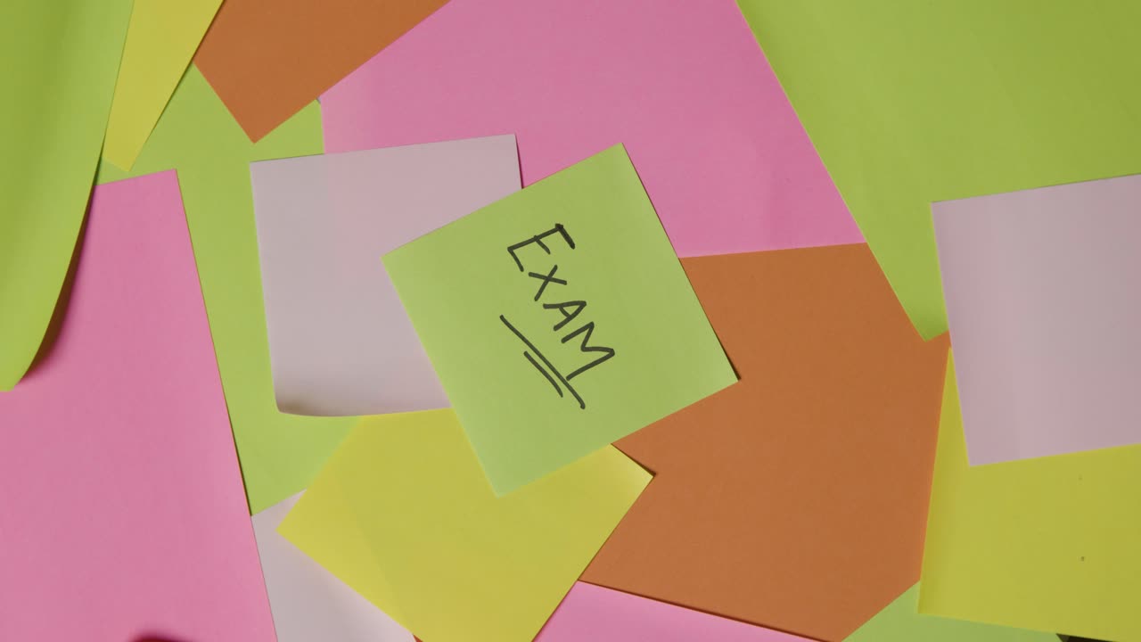 Education Concept Of Revolving Sticky Notes With Exam Written On Top Note