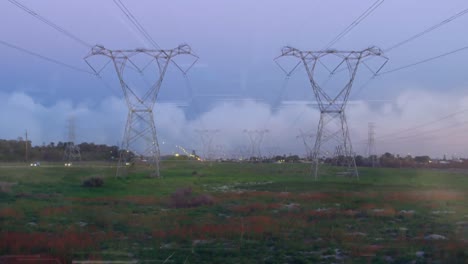 animation of data processing over landscape with electricity pylons