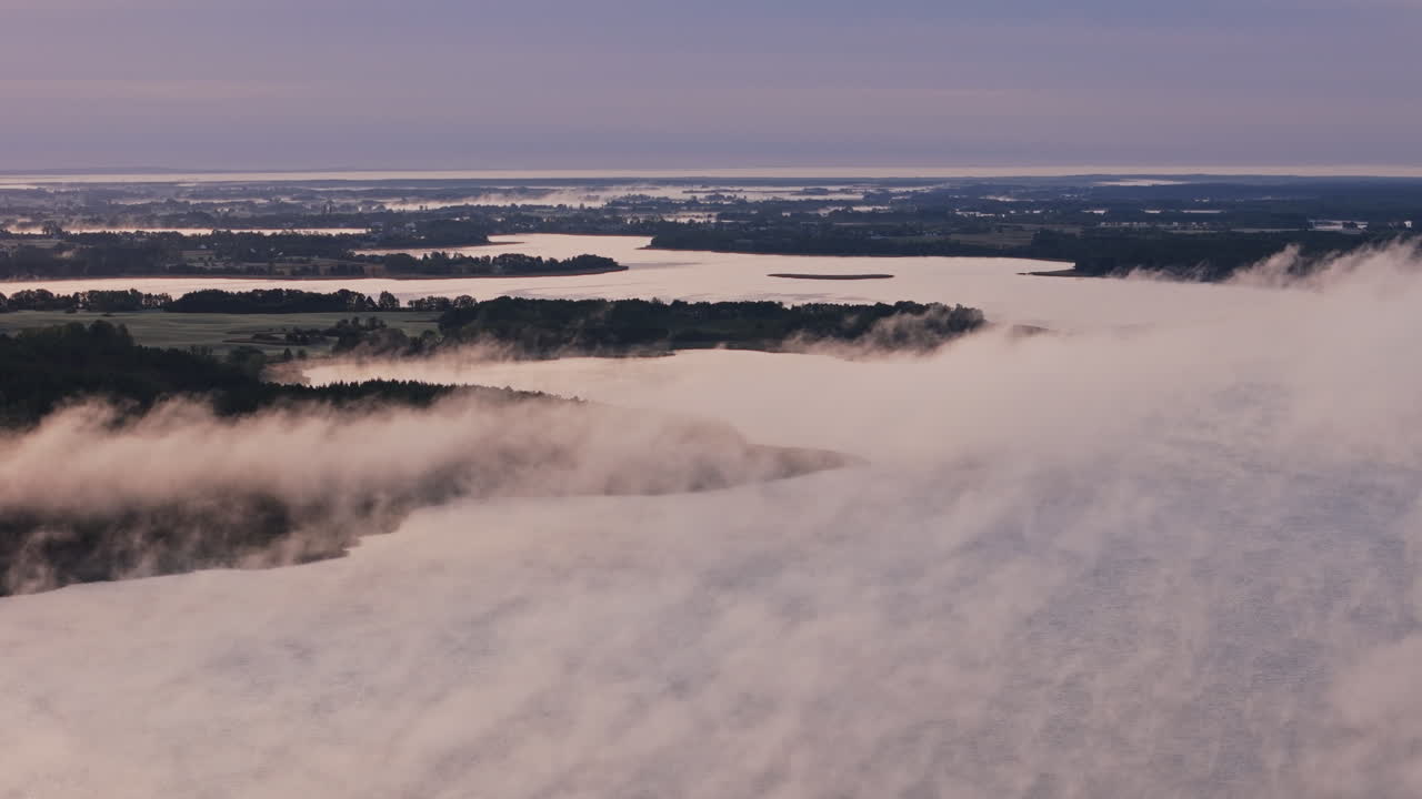 Misty Sunrise Over a Lake and Countryside