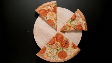 pizza is eaten up random on the table, black background