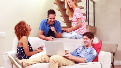 Smiling-friends-drinking-coffee-and-using-devices