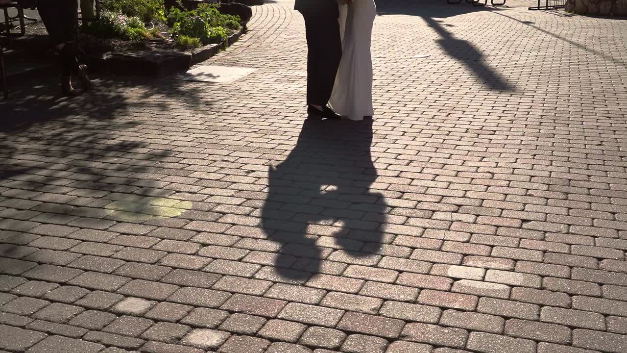 Shadow Silhouette Of Bride And Groom Embracing And Kissing Each Other