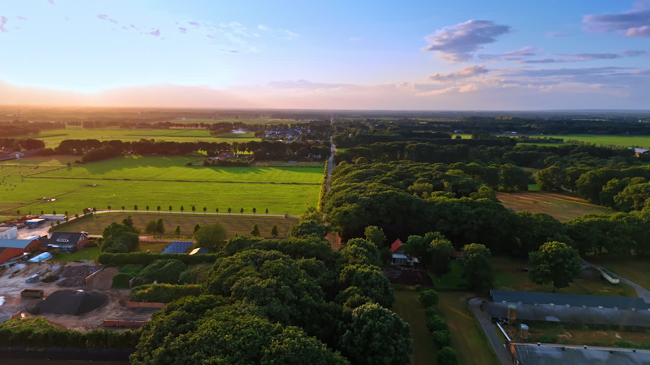 Rural sunset landscape. Golden sunlight bathes lush fields and trees as day shifts to evening in a peaceful rural landscape