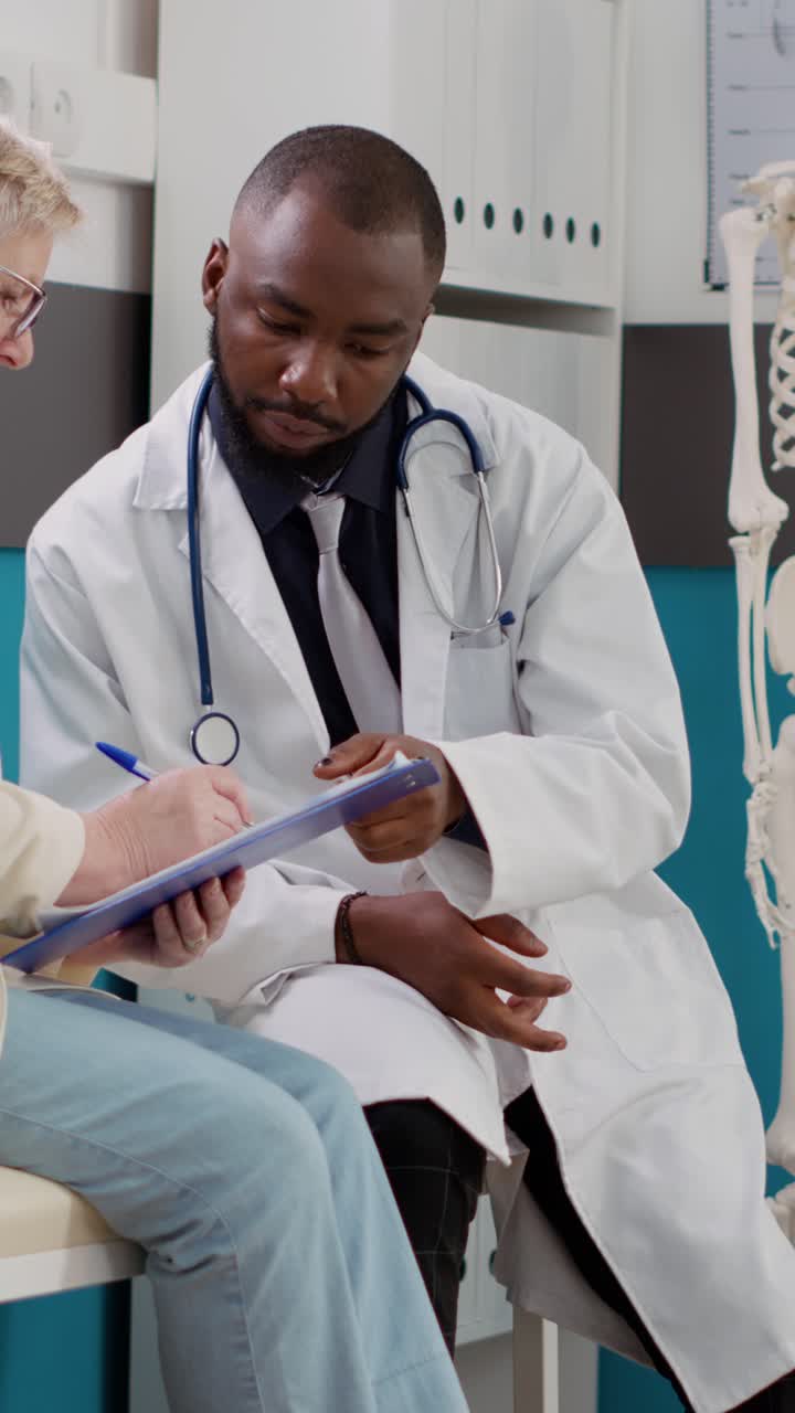 Doctor consulting with senior patient in clinic