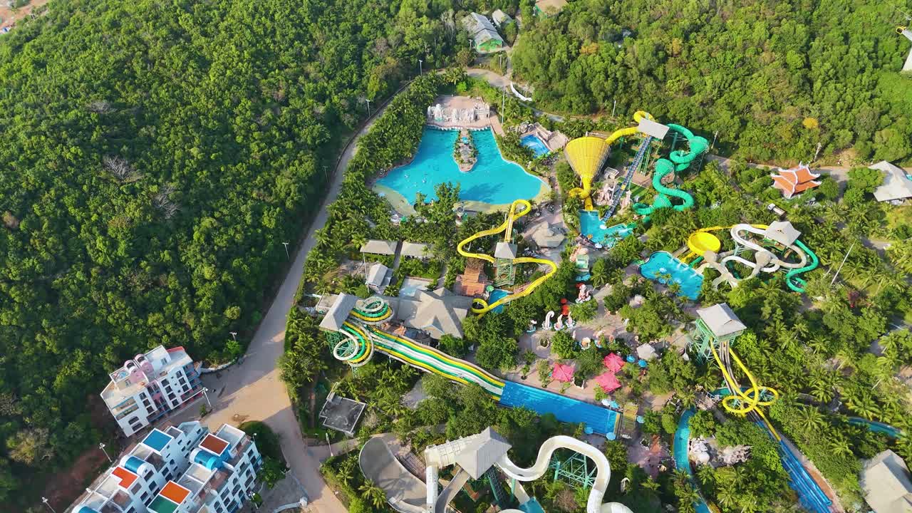Aerial: Water Park during the day in Sunset Town, Phu Quoc Island, Vietnam, establishing drone shot