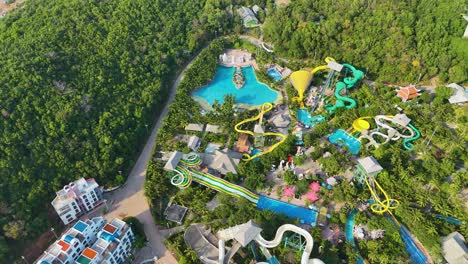 aerial: water park during the day in sunset town, phu quoc island, vietnam, establishing drone shot