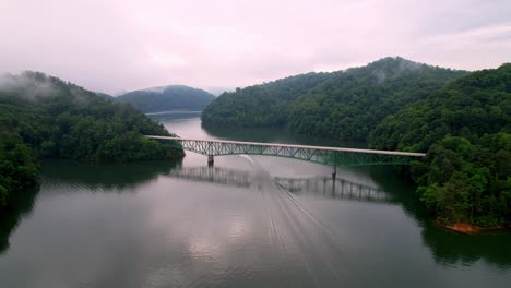 Boat-Crosses-under-Butler-Bridge,-Watauga-Lake,-Watauga-Lake-Tennessee-in-East-Tennessee