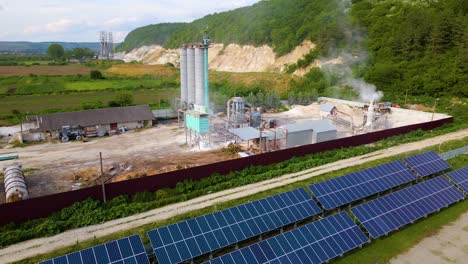 aerial view of electrical power plant with rows of solar photovoltaic panels for producing clean ecological electric energy at industrial area. renewable electricity with zero emission concept.