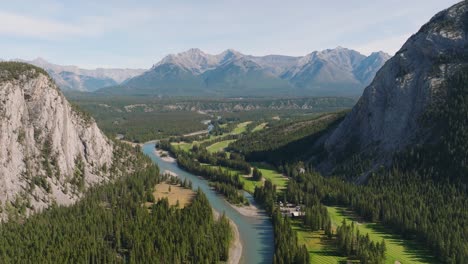 aerial rising over bow river surrounded by pien forest and canadian rockies mountain range at banff national park, alberta, canada