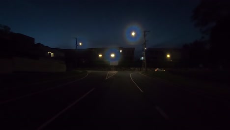 rear facing night driving point of view pov for interior car scene green screen replacement - left turn along quiet city backroads with warehouses