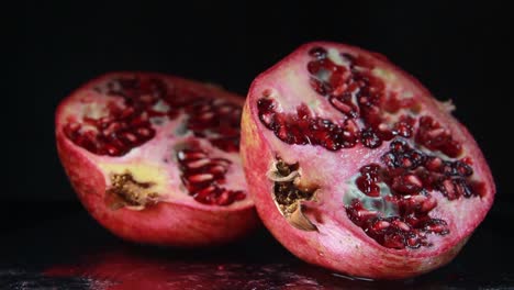 the light moves to the right of the pomegranate on black background