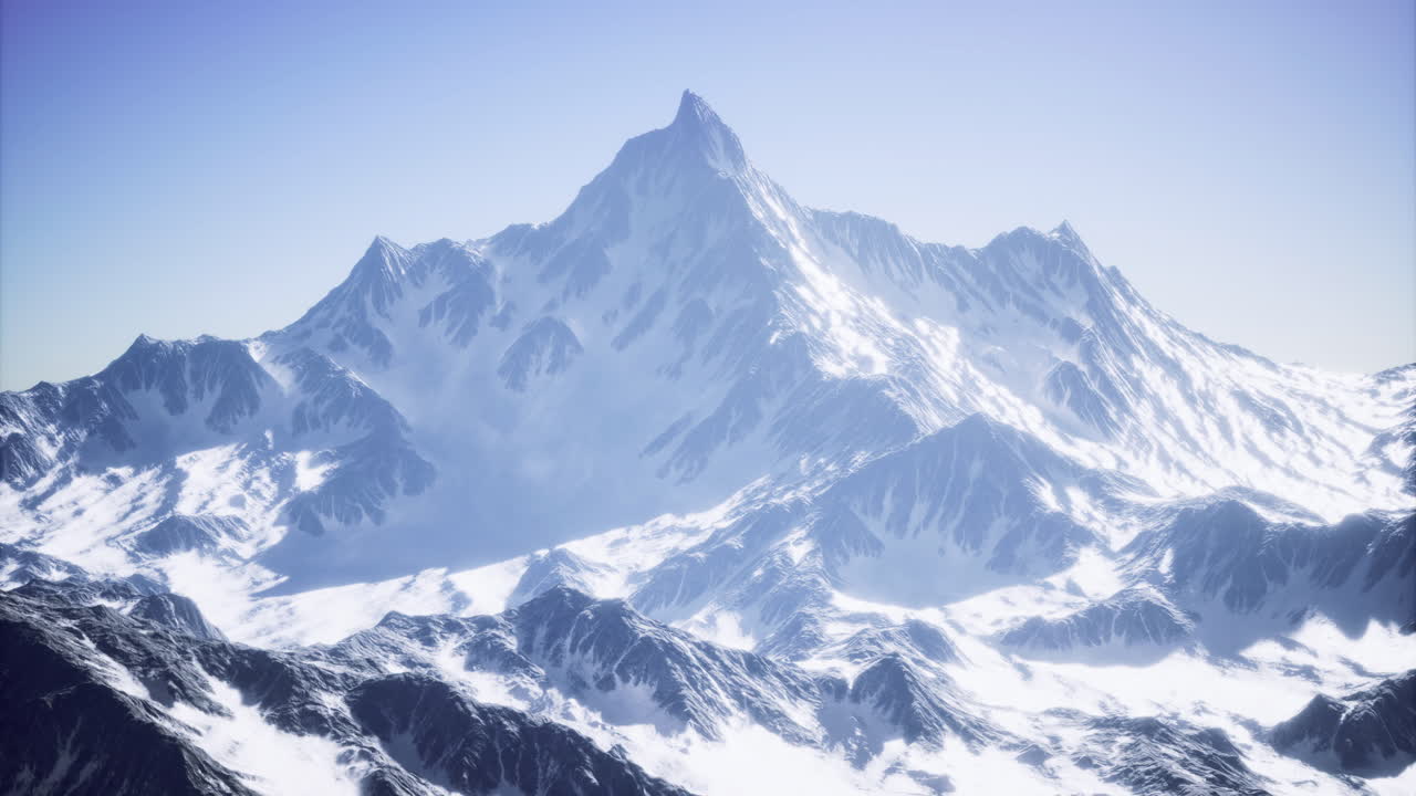 Majestic snow covered mountain range under clear blue sky in winter morning
