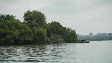 touristic boats and hangzhou city seen from the west lake china