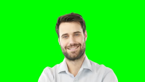 Smiling-man-standing-against-green-screen