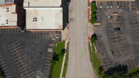 Aerial-birds-eye-overhead-top-down-view-of-empty-downtown-street-and-parking-lots.-Vertically-panning-view.-Limited-people-movement-due-to-world-pandemic.-Dallas,-Texas,-US