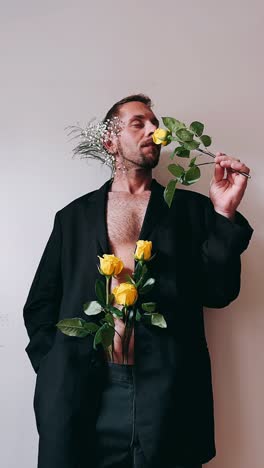 man in black suit with yellow roses