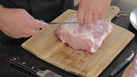 close-up of trimming the fat from a cut of meat