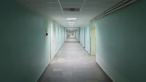 a steadicam shot of a green hallway with a stone floor