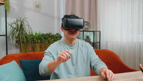 asian man use virtual reality headset typing virtual keyboard play simulation 3d video game at home