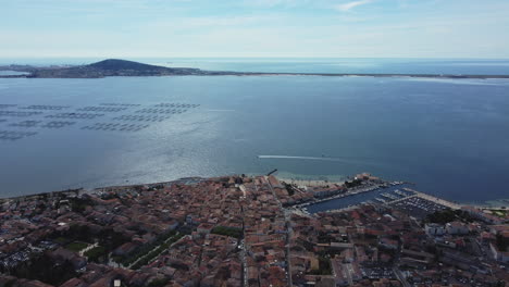 aerial view of a coastal town with harbor and aquaculture farms