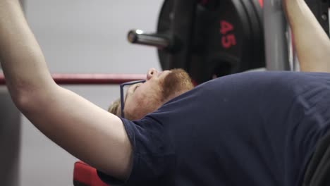 Ordinary-Guy-Laying-on-a-Flat-Bench-Preparing-to-Bench-Press