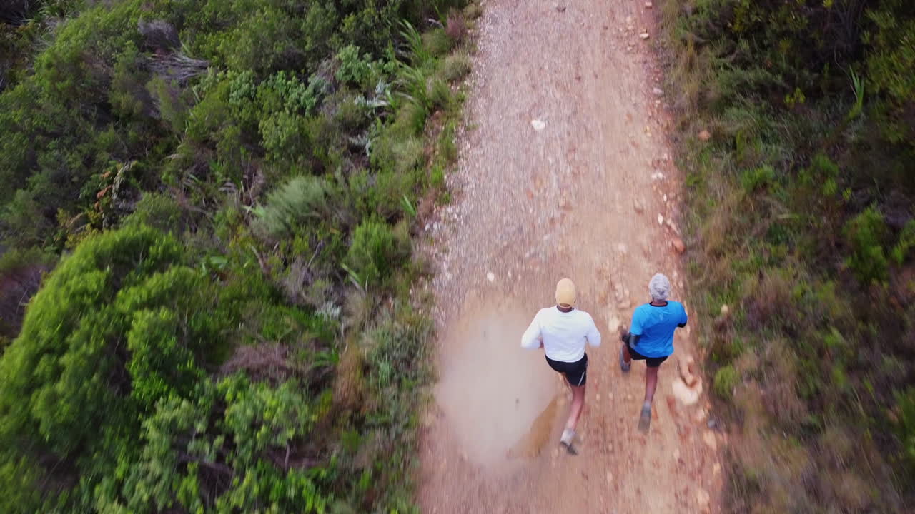 Two men trail running on a dirt road