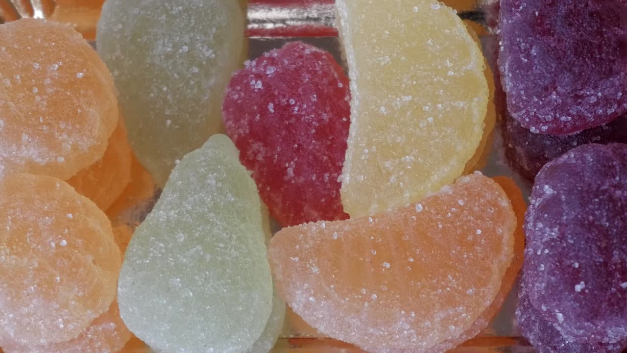 Colorful sugar-coated jelly candies in assorted shapes and flavors