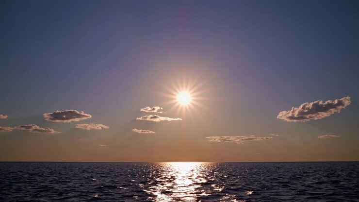 Bright Sun Reflecting on Ocean Water at Sunset