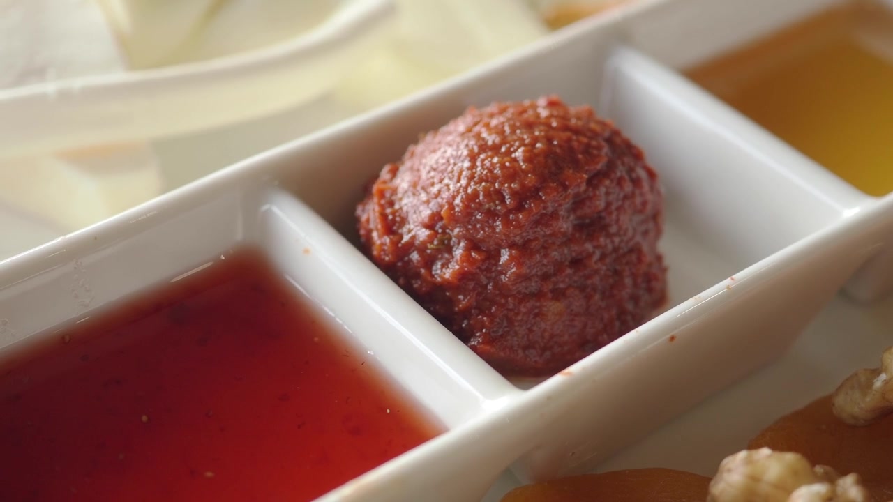 Close-up of Red Pepper Paste, Jam, and Honey in a White Serving Dish