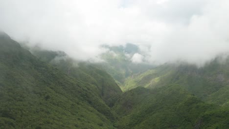 Impresionante-Cordillera-Salvaje-Con-Exuberante-Vegetación-En-Laderas-Cubiertas-De-Nubes