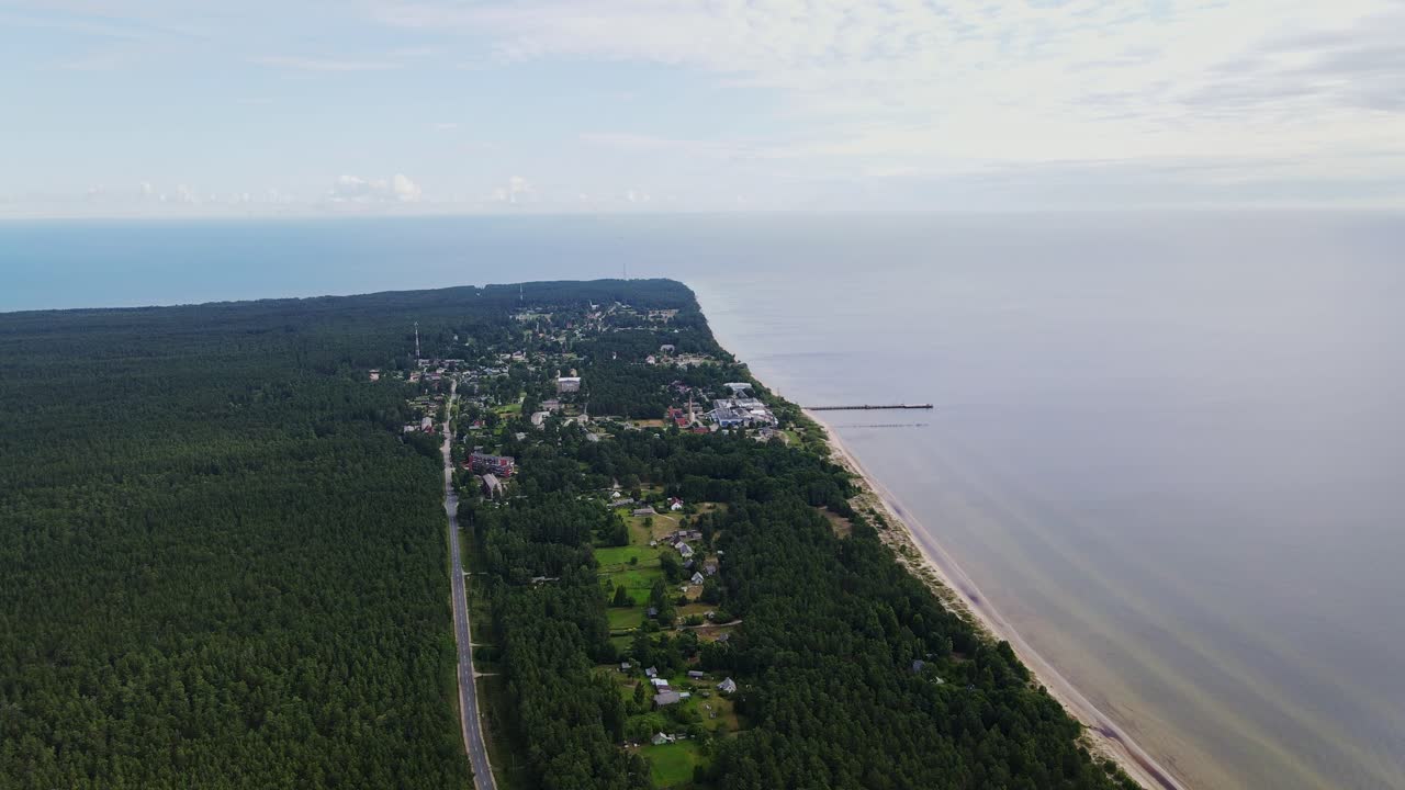 Wide aerial panorama shows Kolka, pine forests and Baltic coastal meeting point