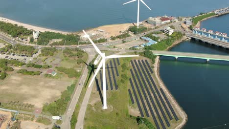 a slowly spinning white wind generator on the sea