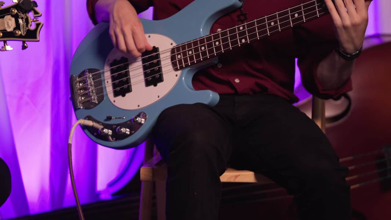 A Bass Player Taps His Foot While Playing The Instrument. Panning up Shot