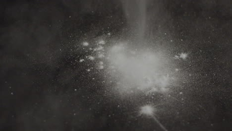 white powder falling on table in slowmotion