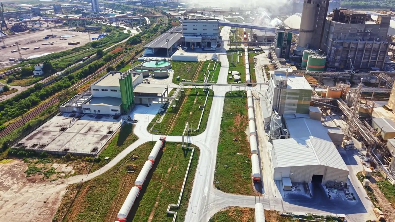 View of industrial area with railways, buildings, and green spaces in a city affected by industrial activities