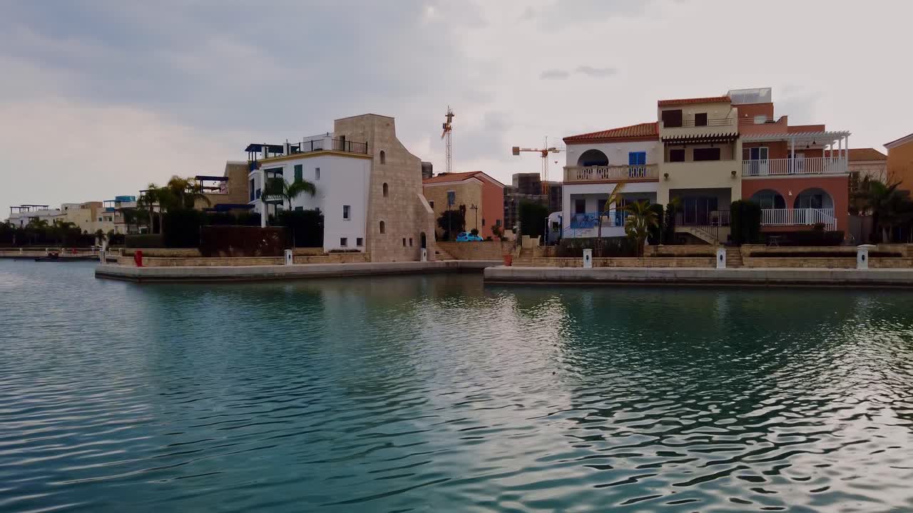 Dwelling houses on marina seashore near the harbor in the evening. Panoramic shot. Limassol, Cyprus