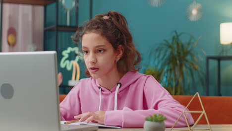 Preteen-school-girl-using-laptop-for-online-lesson,-doing-homework,-distance-learning-education