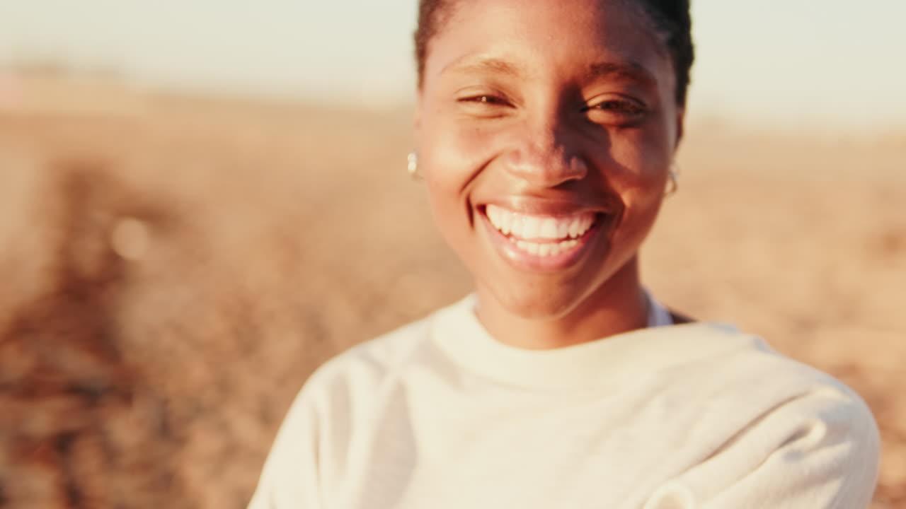 Close-up Portrait of a Happy Young African American Woman Smiling Outdoors