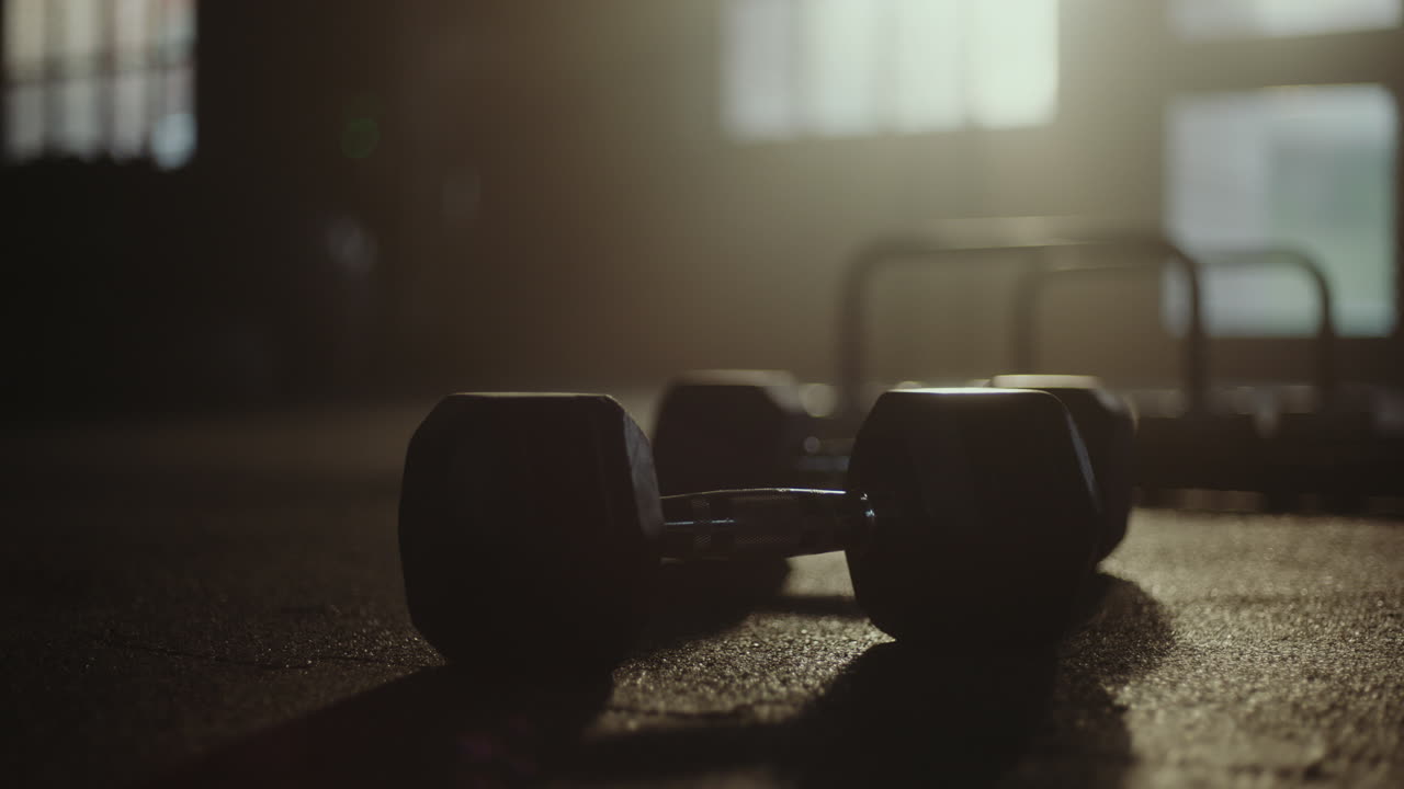 Workout with Dumbbells in a Gym